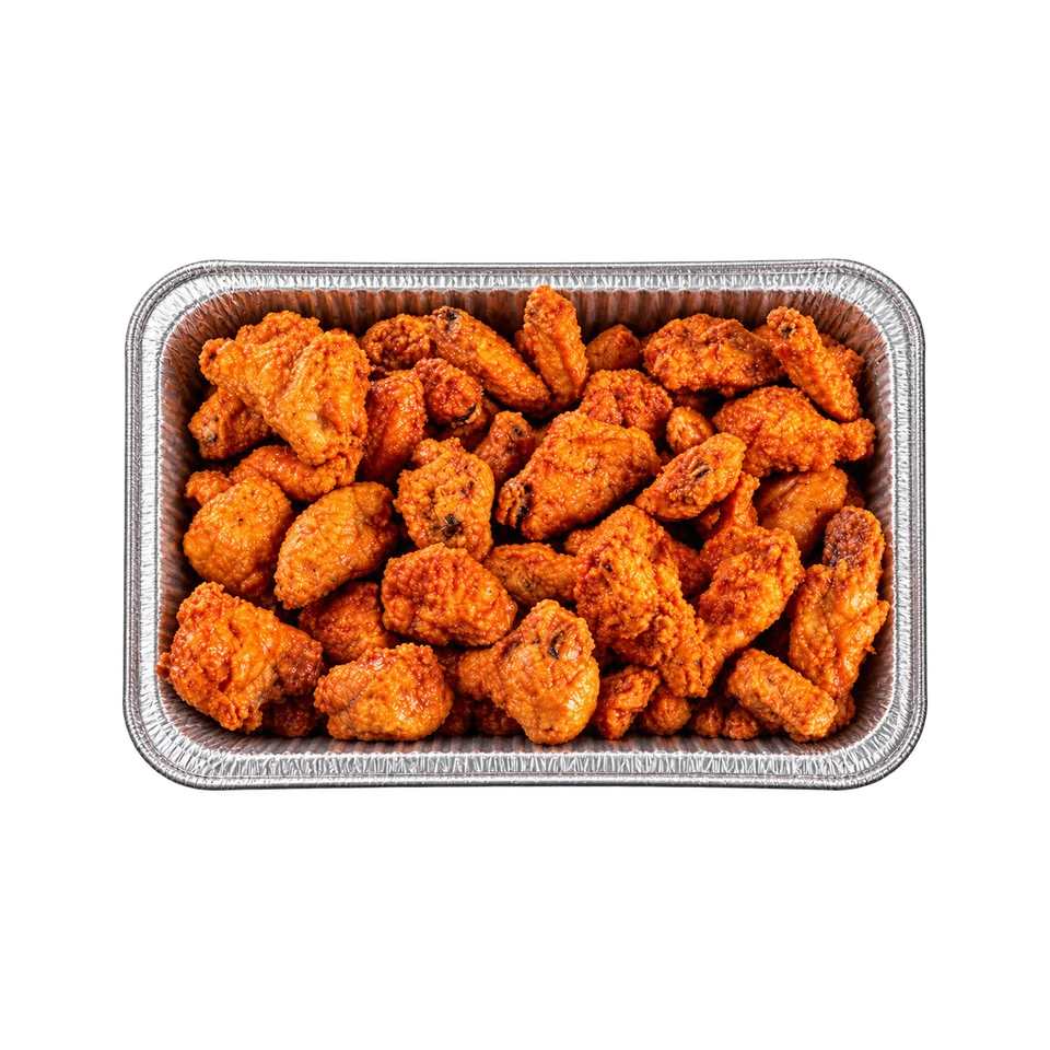 Buffalo chicken wings coated with orange-red sauce in a foil catering tray